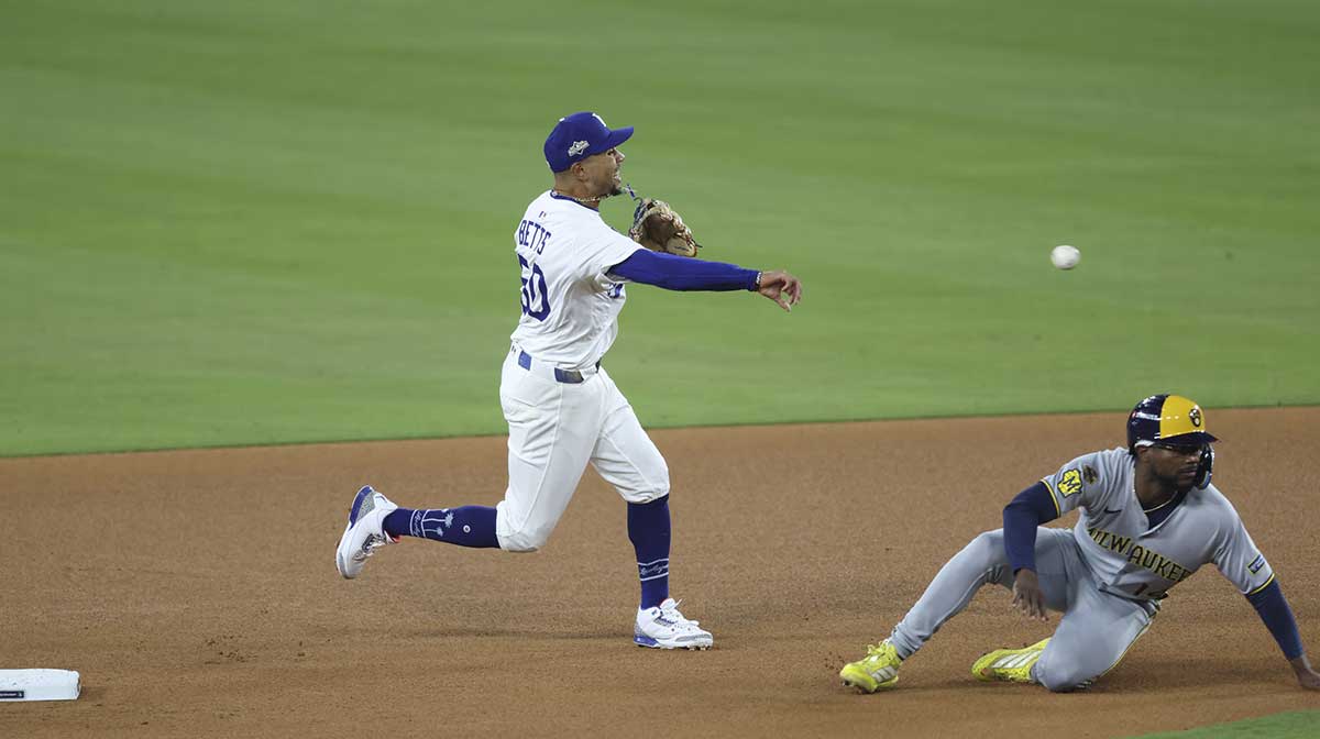 Los Angeles Dodgers shortstop Mookie Betts (50) forces out Milwaukee Brewers shortstop Andruw Monasterio (14) at second base during the eighth inning of game four of the NLCS round for the 2025 MLB playoffs at Dodger Stadium.