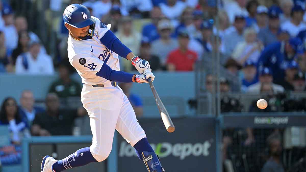 Los Angeles Dodgers shortstop Mookie Betts (50) hits an RBI double against the Milwaukee Brewers in the first inning during game three of the NLCS round for the 2025 MLB playoffs at Dodger Stadium.