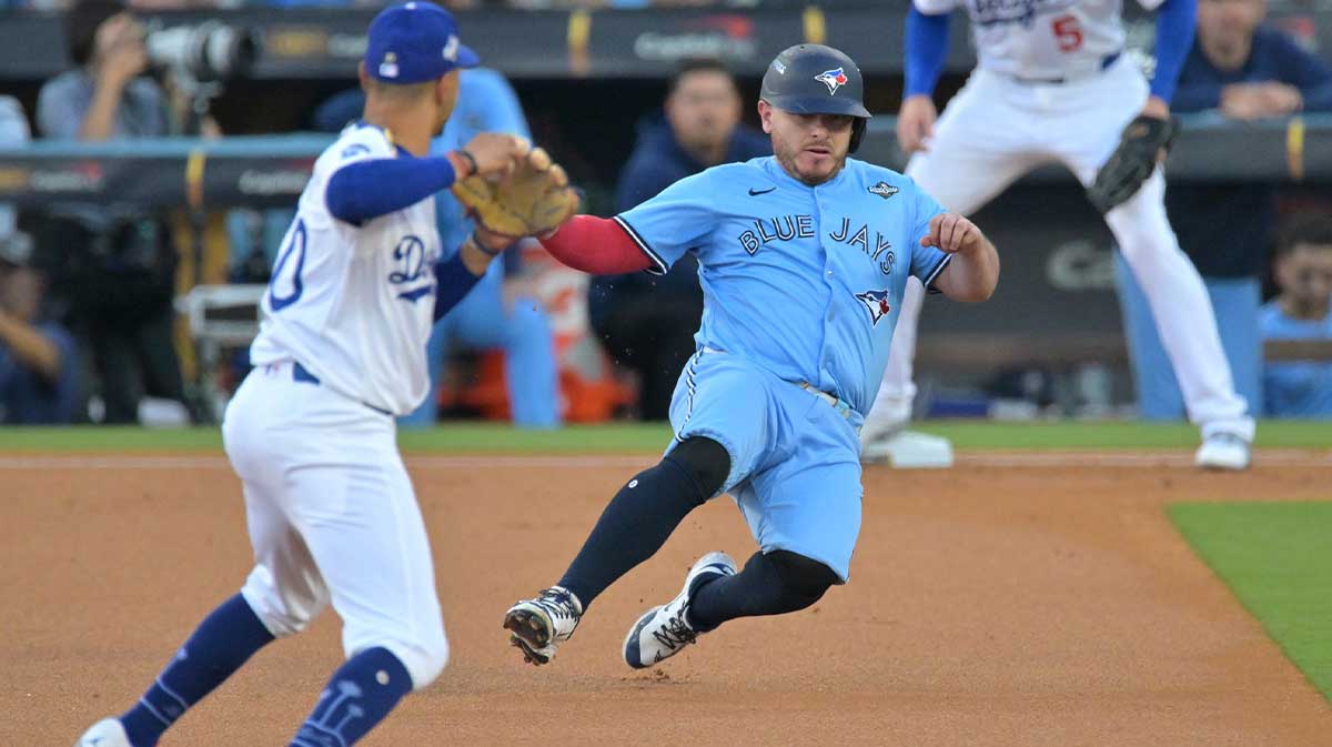 Toronto Blue Jays catcher Alejandro Kirk (30) is out at second base against Los Angeles Dodgers shortstop Mookie Betts (50) in the first inning during game five of the 2025 MLB World Series at Dodger Stadium.
