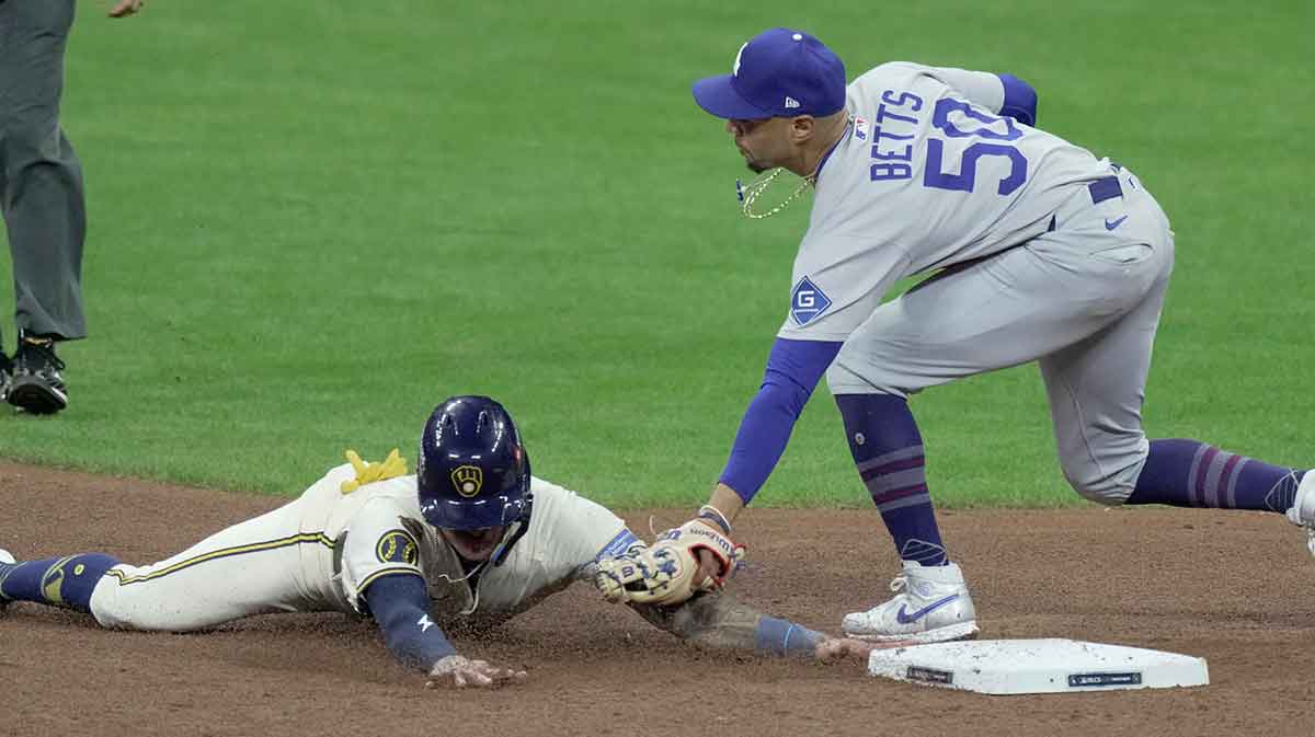Milwaukee Brewers first baseman Jake Bauers (9) is tagged out while trying to steal second base by Los Angeles Dodgers shortstop Mookie Betts (50) during the fifth inning of their National League Championship Series game October 14, 2025 at American Family Field in Milwaukee, Wisconsin.
