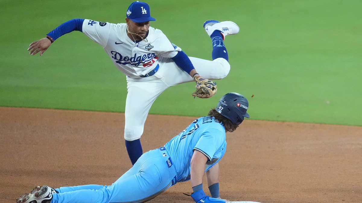 Toronto Blue Jays third baseman Addison Barger (47) is safe at second against Los Angeles Dodgers shortstop Mookie Betts (50) in the seventh inning during game five of the 2025 MLB World Series at Dodger Stadium.