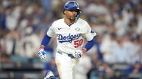 Los Angeles Dodgers shortstop Mookie Betts (50) runs after hitting a single against the Toronto Blue Jays in the eighth inning during game four of the 2025 MLB World Series at Dodger Stadium.