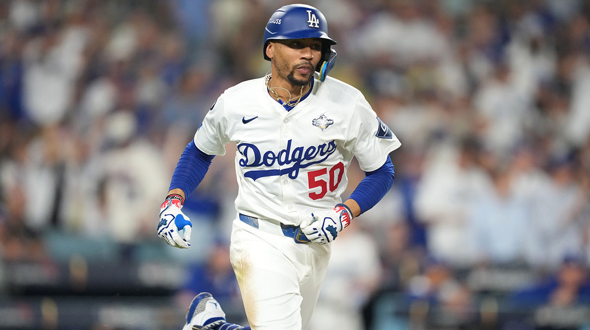 Los Angeles Dodgers shortstop Mookie Betts (50) runs after hitting a single against the Toronto Blue Jays in the eighth inning during game four of the 2025 MLB World Series at Dodger Stadium.