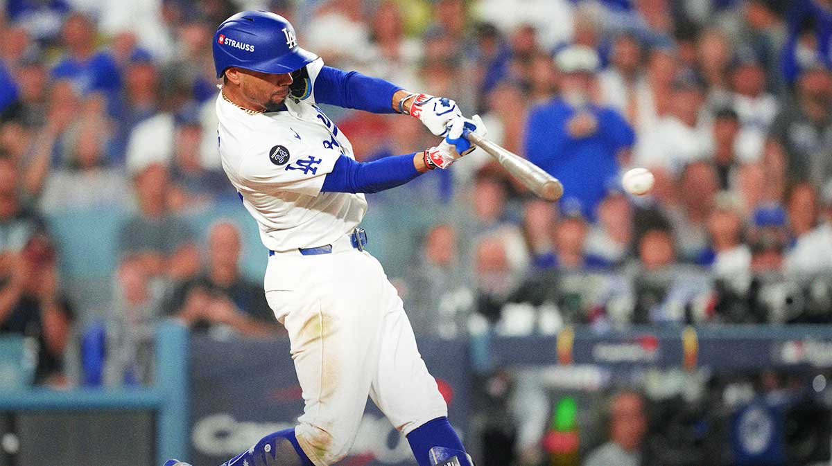 Los Angeles Dodgers shortstop Mookie Betts (50) hits a single against the Toronto Blue Jays in the eighth inning during game four of the 2025 MLB World Series at Dodger Stadium.
