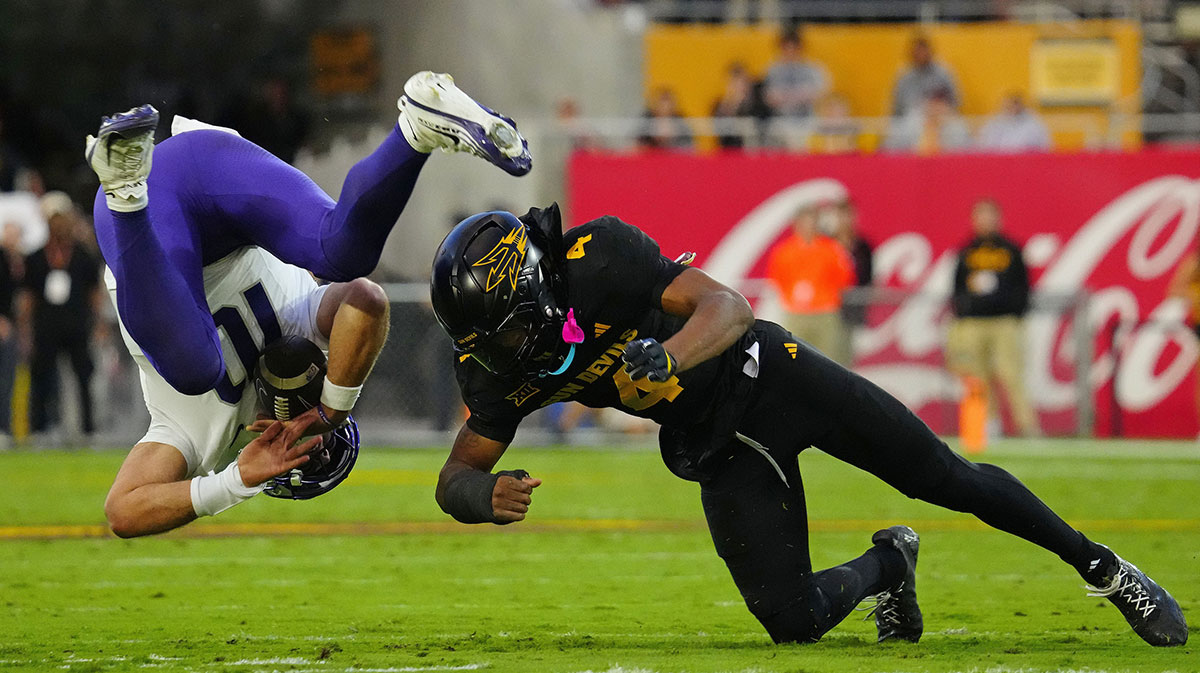 Arizona State defensive back Myles Rowser (4) flips TCU quarterback Josh Hoover (10) on a hit during a game at Mountain America Stadium in Tempe, Ariz. on Sept. 26, 2025.