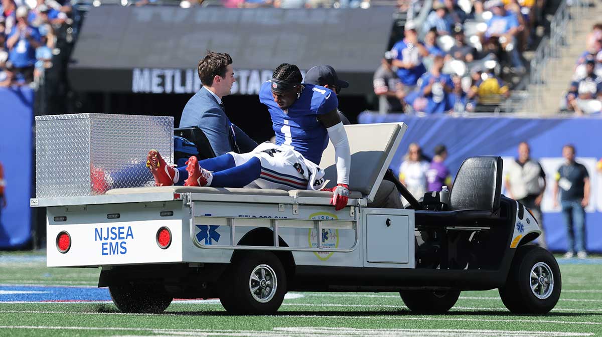 New York Giants wide receiver Malik Nabers (1) is carted off the field following an injury during the second quarter against the Los Angeles Chargers at MetLife Stadium.