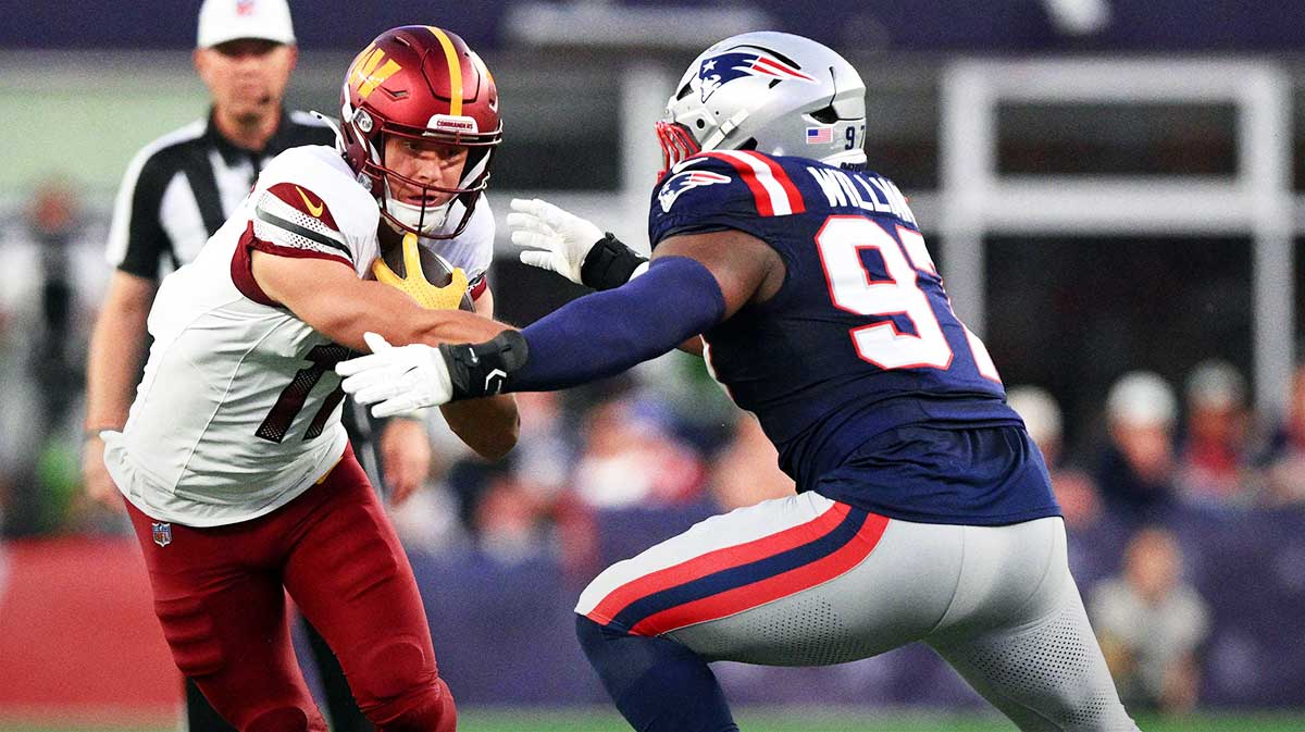 New England Patriots defensive end Milton Williams (97) tackles Washington Commanders wide receiver Luke McCaffrey (11) during the first half at Gillette Stadium.