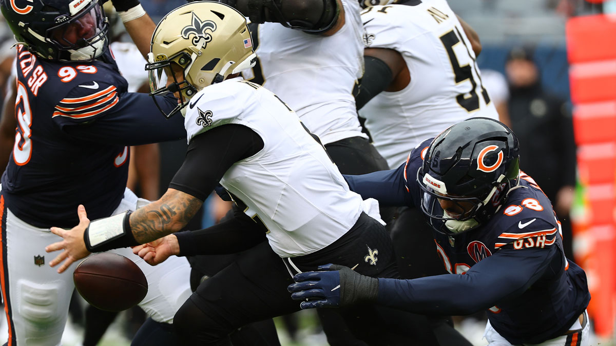 New Orleans Saints quarterback Spencer Rattler (2) fumbles the ball after being hit by Chicago Bears defensive end Montez Sweat (98)