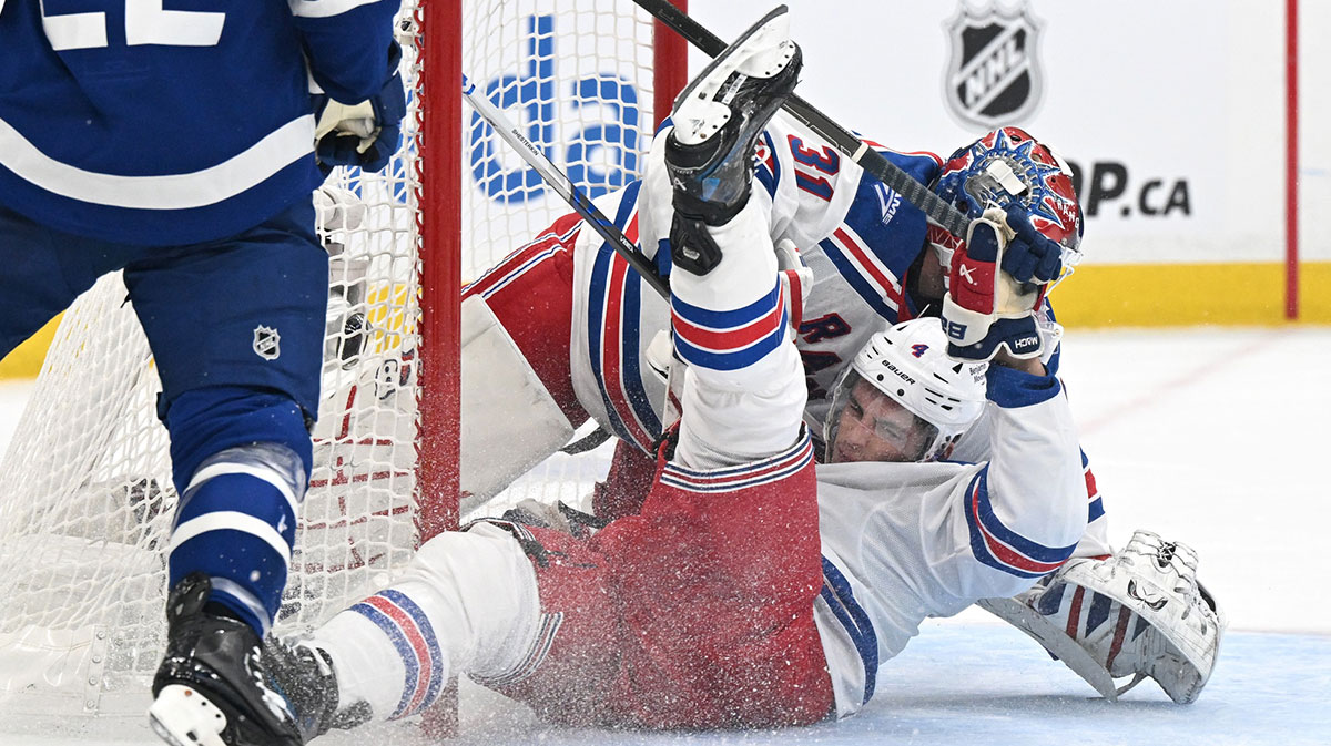 New York Rangers defenseman Braden Schneider (4) collides with goal Igor Shesterkin (31) in the first period against the Toronto Maple Leafs at Scotiabank Arena.