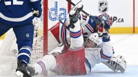 New York Rangers defenseman Braden Schneider (4) collides with goal Igor Shesterkin (31) in the first period against the Toronto Maple Leafs at Scotiabank Arena.