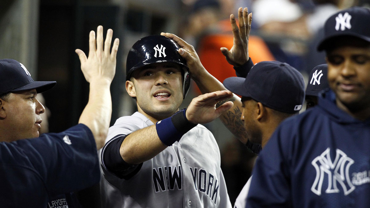 New York Yankees pinch hitter Jesus Montero (middle) is congratulated by teammates after scoring in the eighth inning in game four of the 2011 ALDS against the Detroit Tigers at Comerica Park.