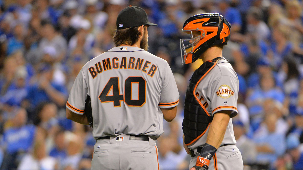 San Francisco Giants starting pitcher Madison Bumgarner (40) talks with catcher Nick Hundley (5) at the mound in the fourth inning against the Kansas City Royals at Kauffman Stadium.