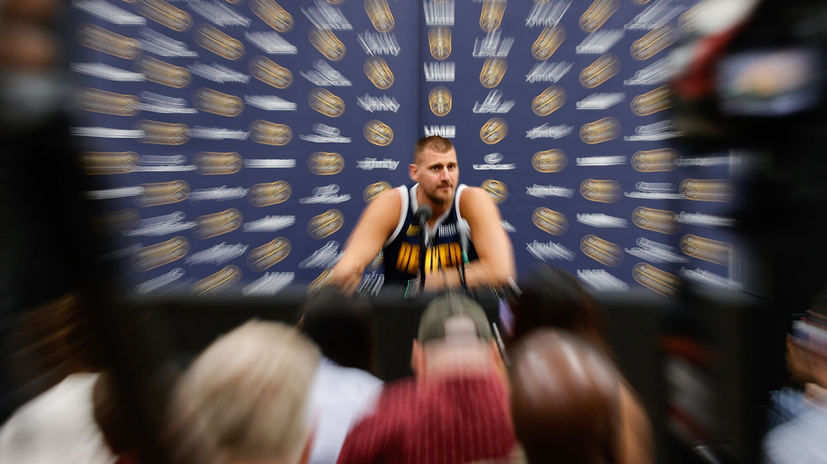 Denver Nuggets player Nikola Jokic (15) takes questions during media day at Ball Arena.