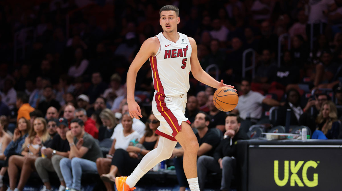 Miami Heat forward Nikola Jovic (5) dribbles the basketball against the Milwaukee Bucks during the second quarter at Kaseya Center. 