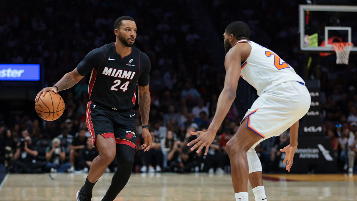 Miami Heat guard Norman Powell (24) dribbles the basketball as New York Knicks guard Mikal Bridges (25) defends during the second quarter at Kaseya Center.