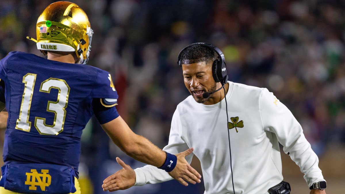 Notre Dame Fighting Irish head coach Marcus Freeman celebrates with quarterback CJ Carr (13) during the first half against the Southern California Trojans at Notre Dame Stadium.