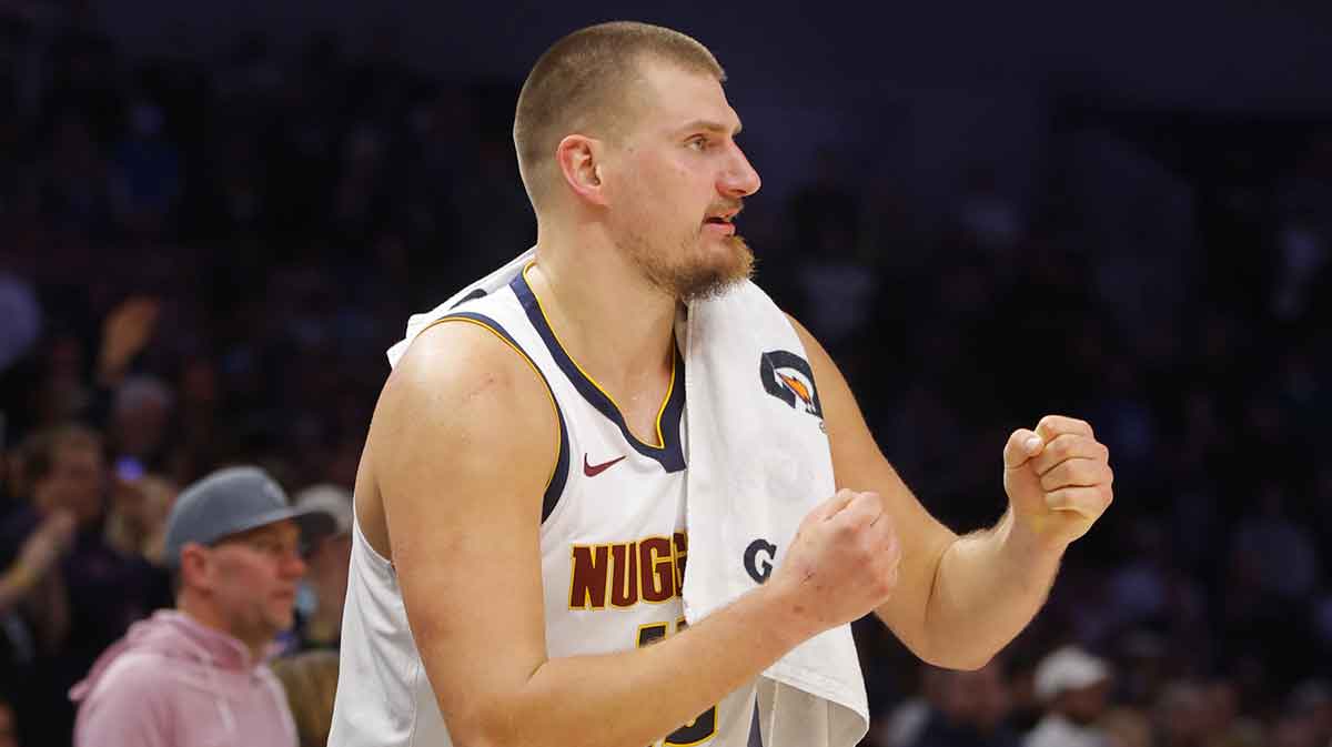 Nuggets center Nikola Jokic (15) cheers on his team.