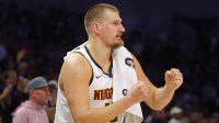 Nuggets center Nikola Jokic (15) cheers on his team.