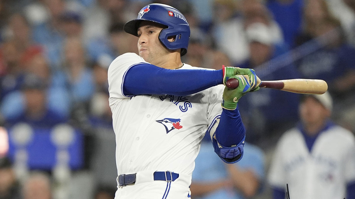 Toronto Blue Jays right fielder George Springer (4) hits a double against the Los Angeles Dodgers in the first inning during game two of the 2025 MLB World Series at Rogers Centre. Mandatory Credit: John E. Sokolowski-Imagn Images