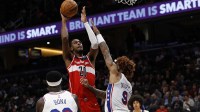 Oct 28, 2025; Washington, District of Columbia, USA; Washington Wizards center Alex Sarr (20) shoots the ball over Philadelphia 76ers guard Kelly Oubre Jr. (9) in the fourth quarter at Capital One Arena. Mandatory Credit: Geoff Burke-Imagn Images