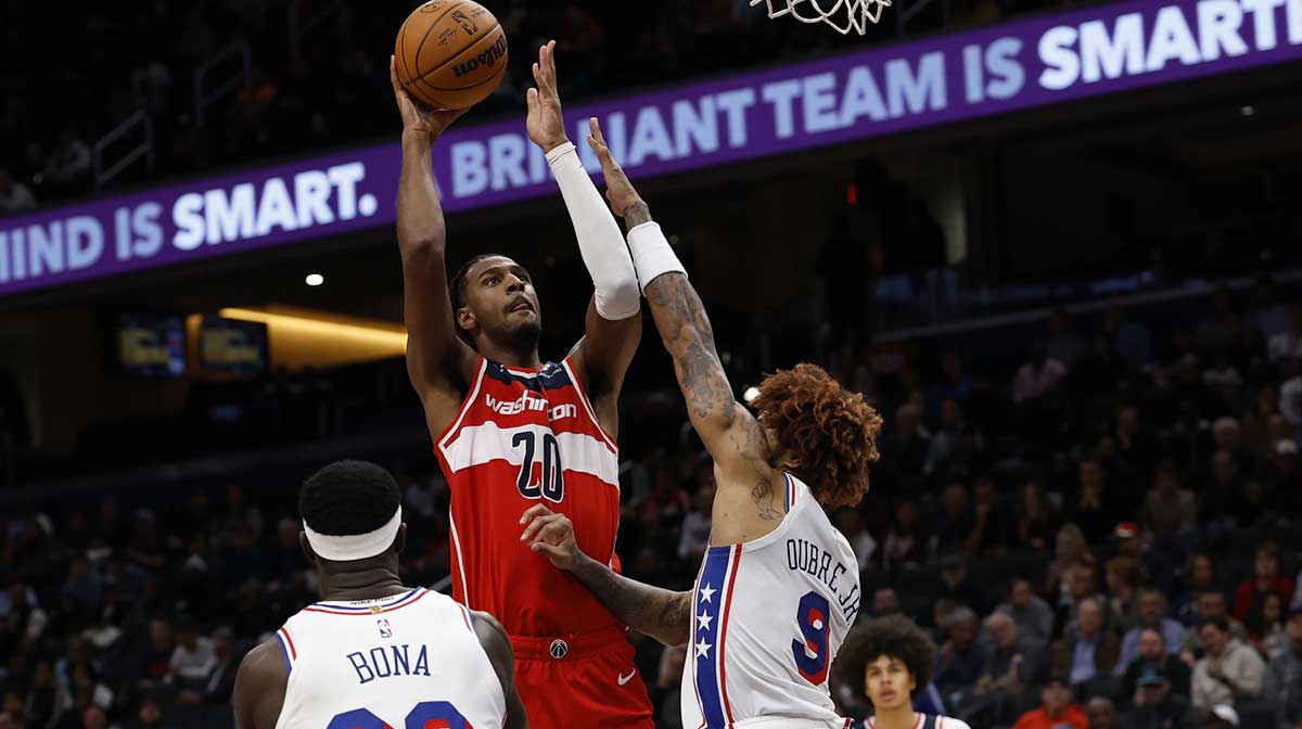 Oct 28, 2025; Washington, District of Columbia, USA; Washington Wizards center Alex Sarr (20) shoots the ball over Philadelphia 76ers guard Kelly Oubre Jr. (9) in the fourth quarter at Capital One Arena. Mandatory Credit: Geoff Burke-Imagn Images