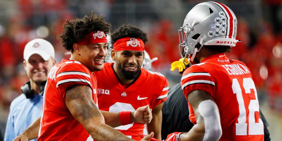 Ohio State Buckeyes wide receiver Jaxon Smith-Njigba (11) and Ohio State Buckeyes wide receiver Chris Olave (2) congratulate Ohio State Buckeyes wide receiver Emeka Egbuka (12) after a long run during the third quarter of a NCAA Division I football game between the Ohio State Buckeyes and the Akron Zips on Saturday, Sept. 25, 2021 at Ohio Stadium in Columbus, Ohio. Cfb Akron Zips At Ohio State Buckeyes