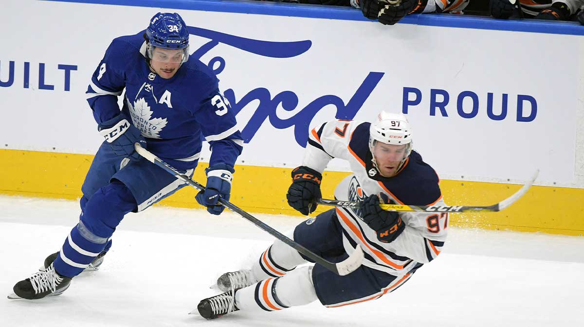 Edmonton Oilers forward Connor McDavid (97) takes the puck away from Toronto Maple Leafs forward Auston Matthews (34) in the first period at Scotiabank Arena.