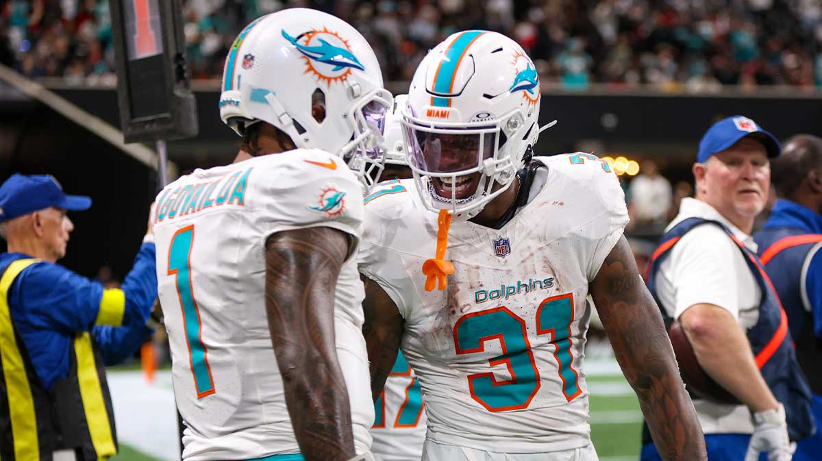 Miami Dolphins running back Ollie Gordon II (31) celebrates with quarterback Tua Tagovailoa (1) after a touchdown against the Atlanta Falcons in the fourth quarter at Mercedes-Benz Stadium.