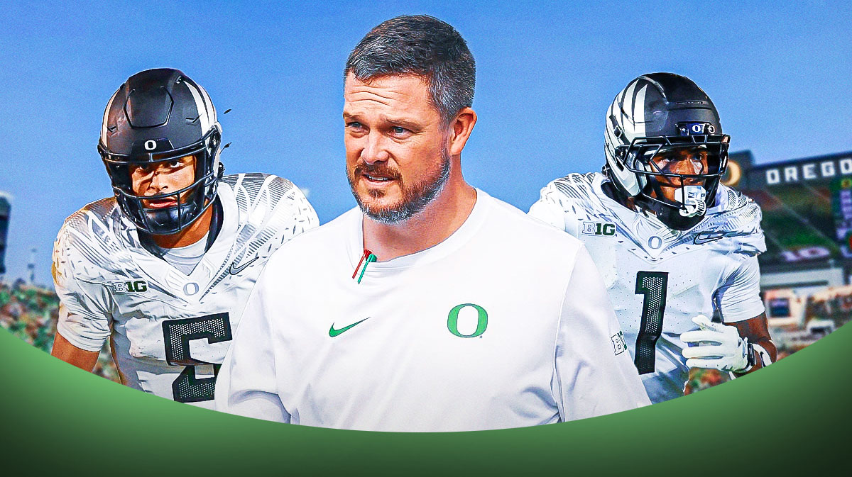 Dan Lanning in the middle, with Dante Moore and Dakorien Moore on the outside.