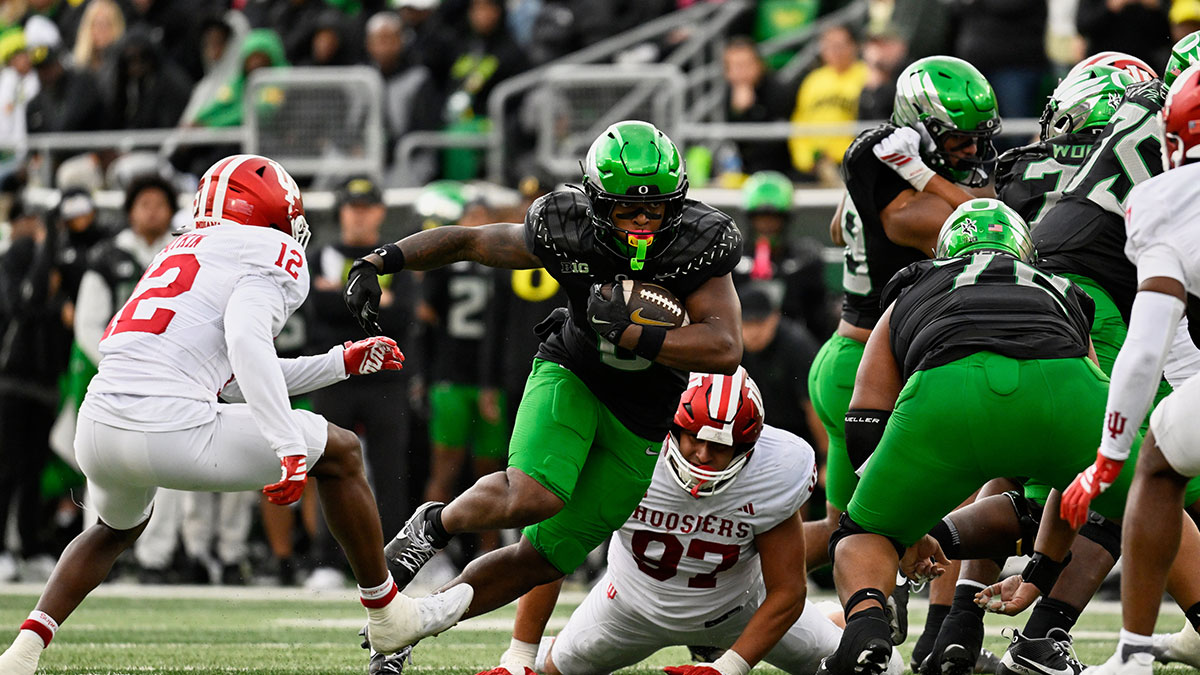 Oregon Ducks running back Jordon Davison (0) runs the ball against Indiana Hoosiers defensive back Devan Boykin (12) and defensive lineman Mario Landino (97) during the second quarter at Autzen Stadium.