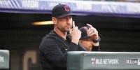 Cleveland Guardians bench coach Craig Albernaz (55) calls in a play in the first inning against the Colorado Rockies at Coors Field.