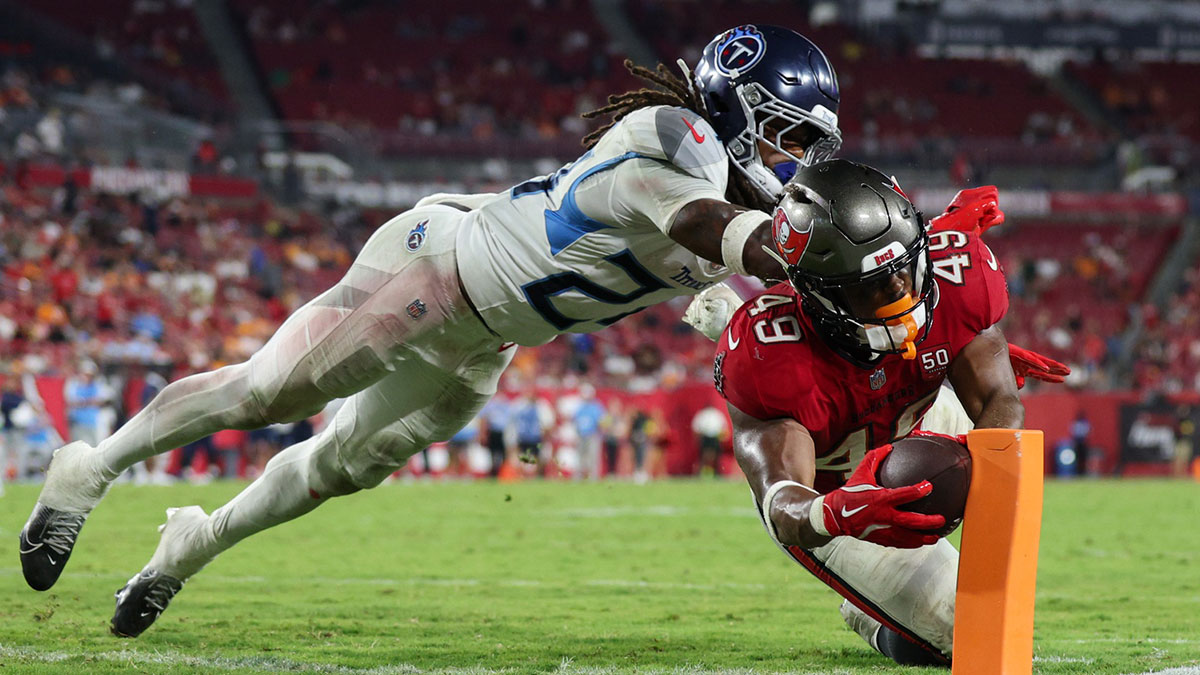 Tampa Bay Buccaneers running back Owen Wright (49) dives into the end zone on a play that was celled back for holding past Tennessee Titans defensive back Julius Wood (24) in the fourth quarter during a preseason game at Raymond James Stadium.