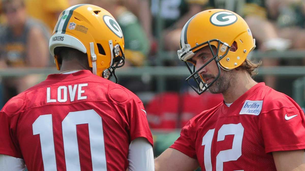 Green Bay Packers quarterback Aaron Rodgers (12) talks with quarterback Jordan Love (10) during the first day of training camp on July 28, 2021 in Green Bay, Wis.