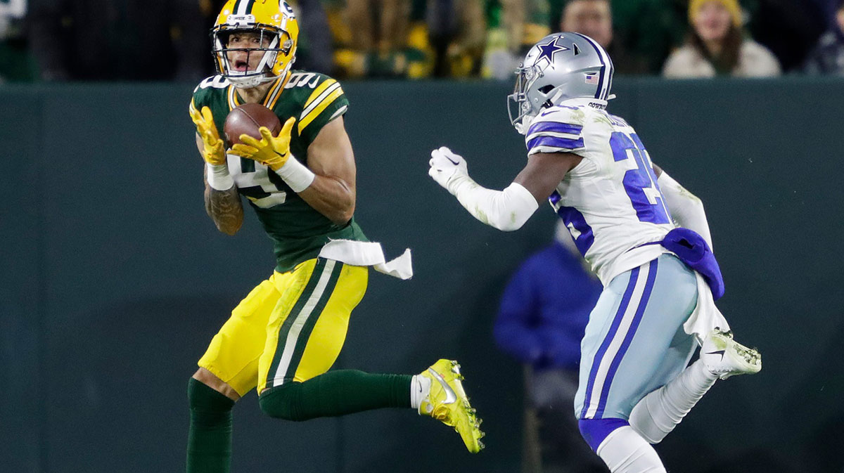 Green Bay Packers wide receiver Christian Watson (9) pulls down a touchdown reception against Dallas Cowboys cornerback DaRon Bland (26) in the fourth quarter during their football game Sunday, November 13, at Lambeau Field in Green Bay, Wis.