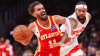 Atlanta Hawks guard Trae Young (11) is fouled by Toronto Raptors forward Brandon Ingram (3) in the second quarter at State Farm Arena.