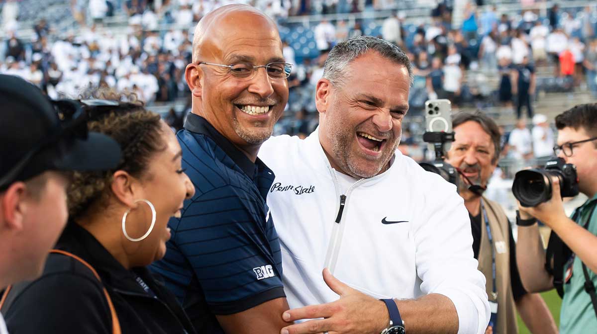 Penn State Athletic Director Pat Kraft, right, laughs with head coach James Franklin following a 46-11 win over Nevada, Saturday, August 30, 2025, in State College, Pa.