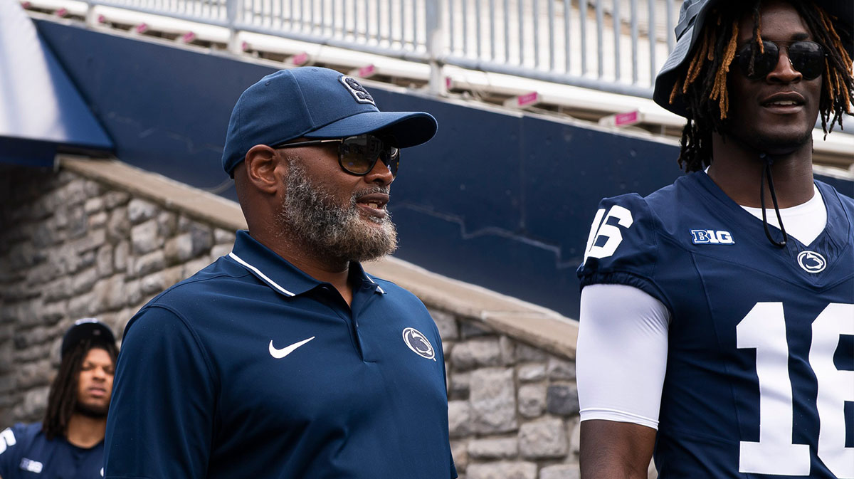 Penn State cornerbacks coach Terry Smith talks with CB Elliot Washington II (16) during football media day at Beaver Stadium on Sunday, August 6, 2023, in State College.