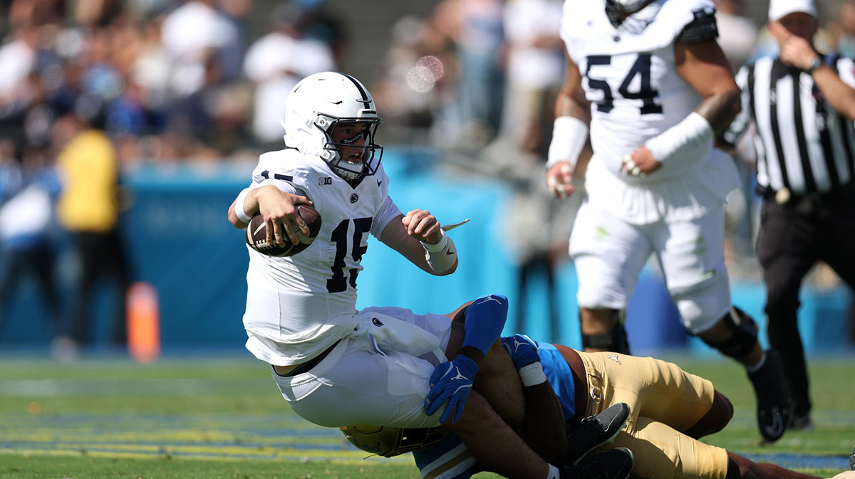 Penn State Nittany Lions quarterback Drew Allar (15) is tackled by UCLA Bruins linebacker Jonjon Vaughns (6) during the second quarter at Rose Bowl.