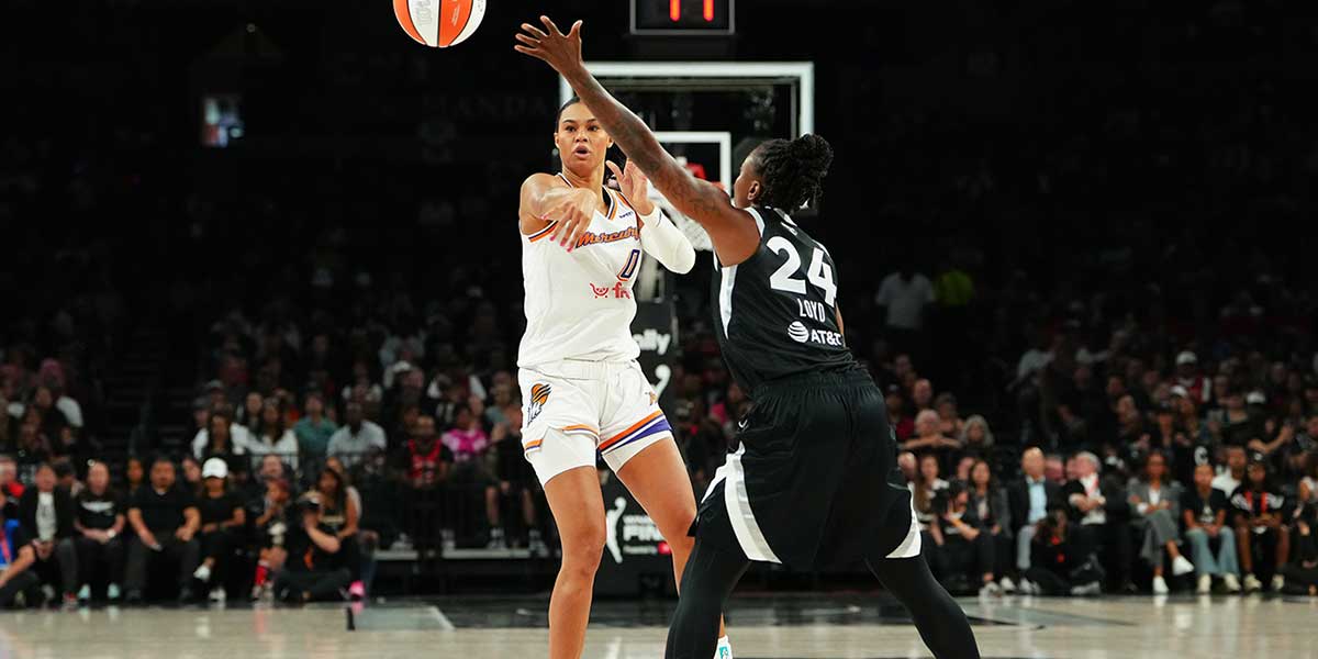Phoenix Mercury forward Satou Sabally (0) makes a pass over the arm of Las Vegas Aces guard Jewell Loyd (24) during the second quarter of game one of the 2025 WNBA Finals at Michelob Ultra Arena.