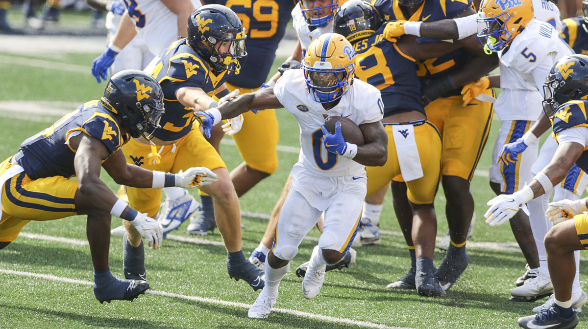 Pittsburgh Panthers running back Desmond Reid (0) runs the ball during the first quarter against the West Virginia Mountaineers at Milan Puskar Stadium.