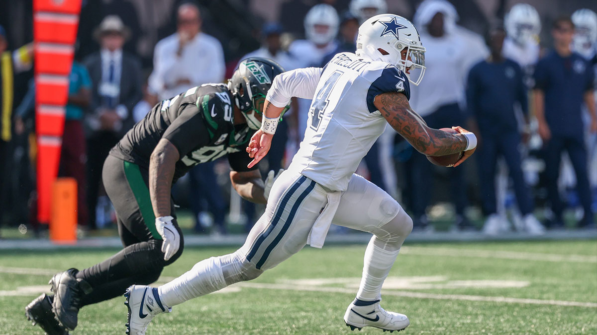 Dallas Cowboys quarterback Dak Prescott (4) scrambles against the New York Jets during the second half at MetLife Stadium.