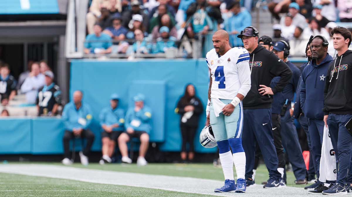 Dallas Cowboys quarterback Dak Prescott (4) looks on from the sideline during the game against the Carolina Panthers at Bank of America Stadium.