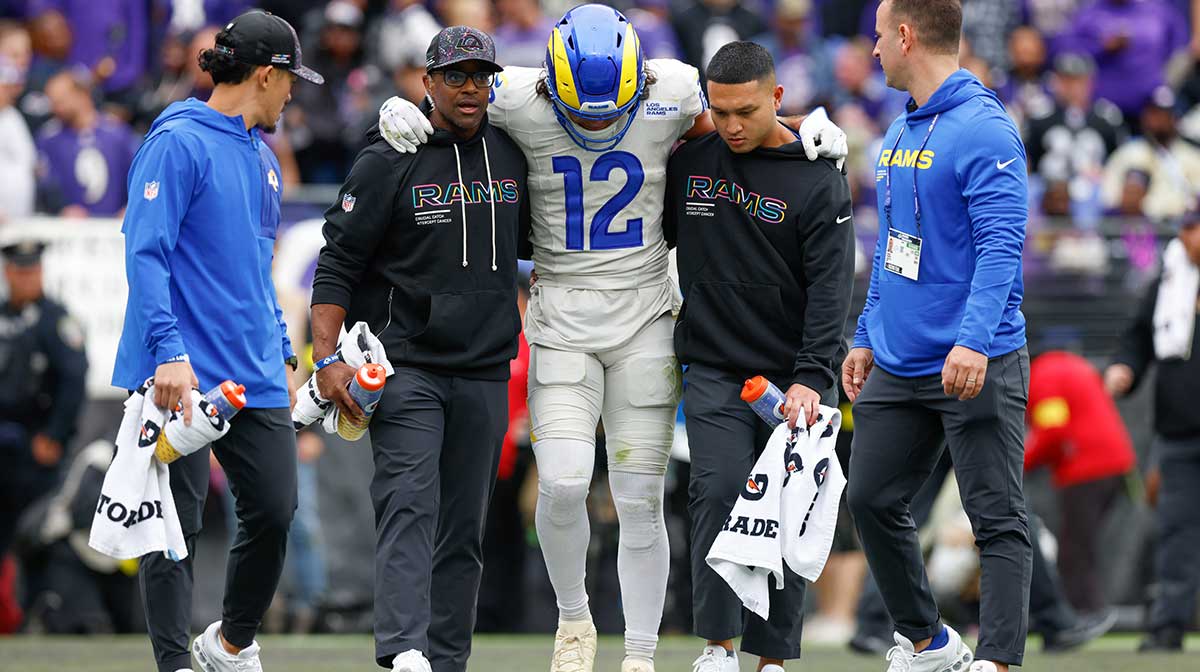 Los Angeles Rams wide receiver Puka Nacua (12) is helped off the field by trainers during the second quarter of the game against the Baltimore Ravens at M&T Bank Stadium.