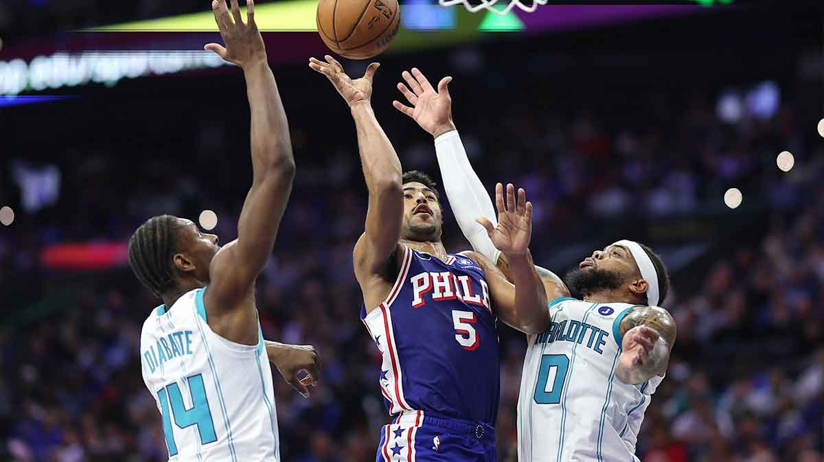 Philadelphia 76ers guard Quentin Grimes (5) drives for a shot between Charlotte Hornets forward Moussa Diabate (14) and Miles Bridges (0) during the second quarter at Xfinity Mobile Arena.