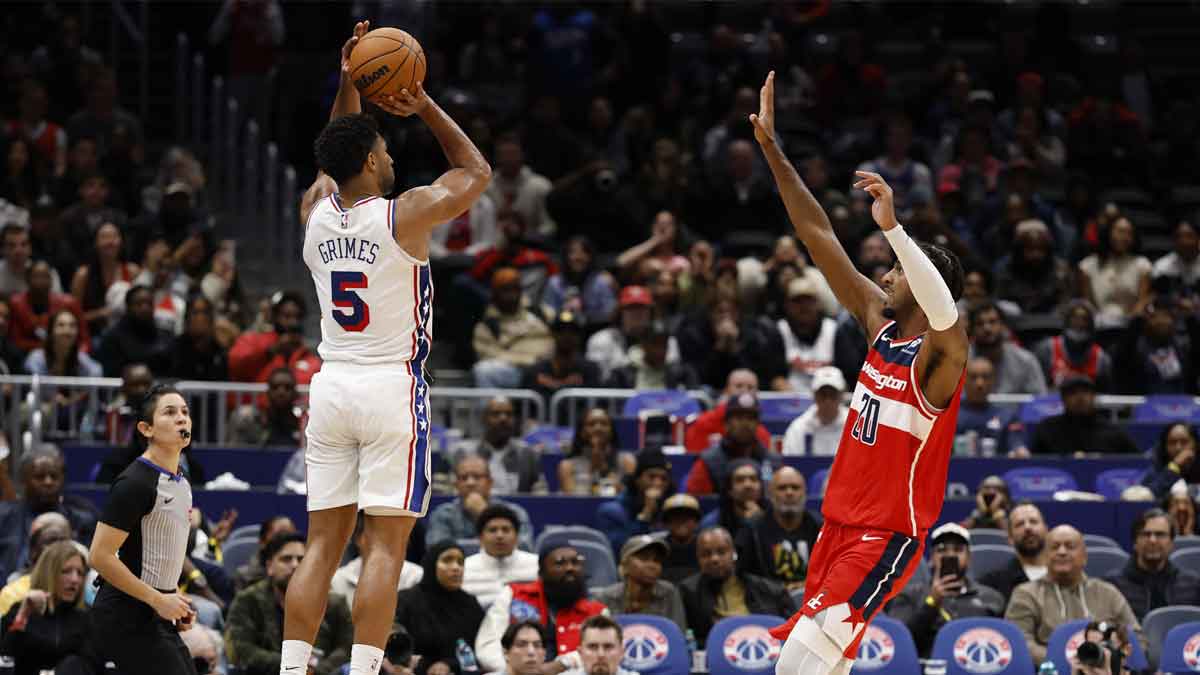 Philadelphia 76ers guard Quentin Grimes (5) makes a game-tying three point field goal over Washington Wizards center Alex Sarr (20) in the final seconds of the court quarter at Capital One Arena.
