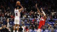 Philadelphia 76ers guard Quentin Grimes (5) makes a game-tying three point field goal over Washington Wizards center Alex Sarr (20) in the final seconds of the court quarter at Capital One Arena.