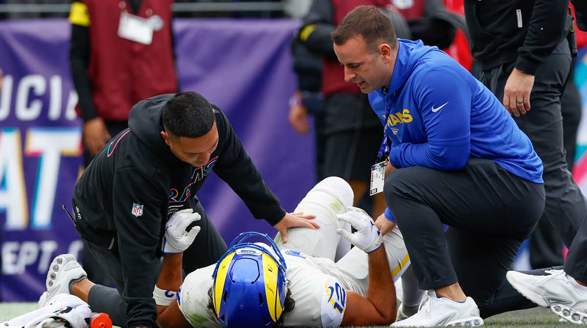 Los Angeles Rams wide receiver Puka Nacua (12) is checked on by trainers during the second quarter of the game against the Baltimore Ravens at M&T Bank Stadium.