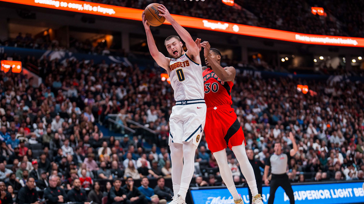 Toronto Raptors guard Ochai Agbaji (30) battles for the rebound with Denver Nuggets guard Christian Braun (0) in the first half at Rogers Arena.