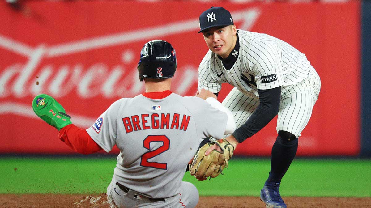Boston Red Sox third baseman Alex Bregman (2) is forced out by New York Yankees shortstop Anthony Volpe (11) at second base in the ninth inning during game three of the Wildcard round for the 2025 MLB playoffs at Yankee Stadium.