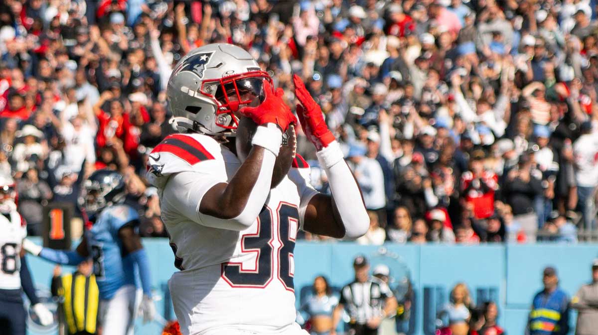 New England Patriots running back Rhamondre Stevenson (38) celebrates with his teammates after touchdown against the Tennessee Titans during the second half at Nissan Stadium.